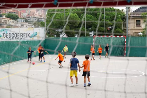 Alumnes de primaria al pati de l'escola Jesuites Gracia jugant a futbol